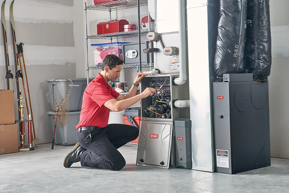 A Bryant Lincoln technician servicing a hot water boiler