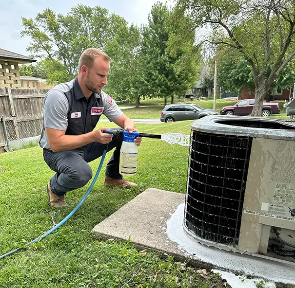 Bryant technician servicing an outdoor AC unit