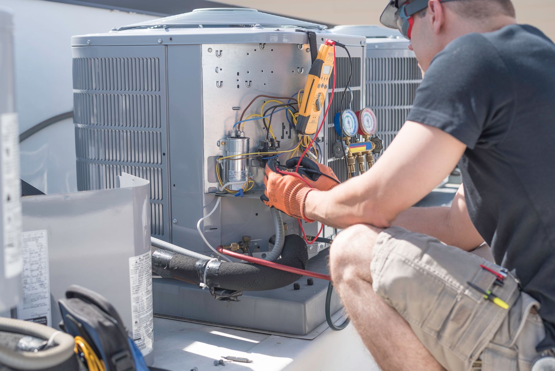 HVAC technician inspecting wiring during a maintenance visit